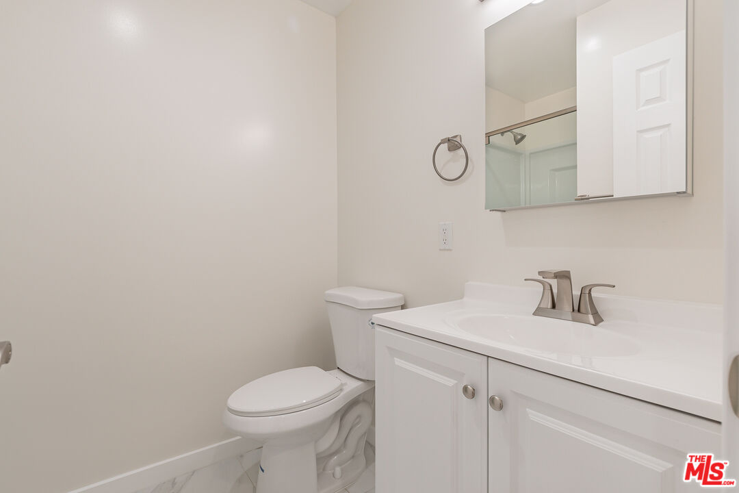 1049 Sonora Avenue, Unit A Glendale, CA 91201 - Photo 7 of 13 a bathroom with a sink a toilet and mirror