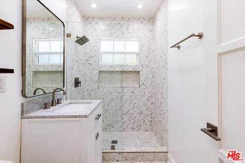 a bathroom with a sink a vanity and a mirror
