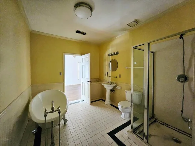 a bathroom with a sink mirror vanity and toilet