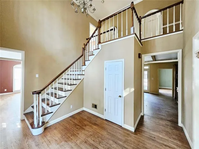 a view of staircase with lots of frames on wall and wooden floor