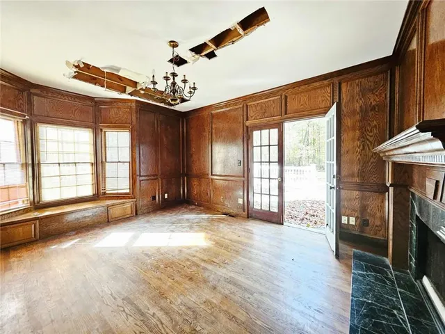 a view of a livingroom with a fireplace and window