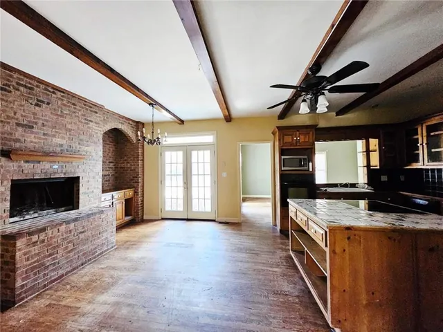 a kitchen with stainless steel appliances granite countertop a stove a sink and a microwave