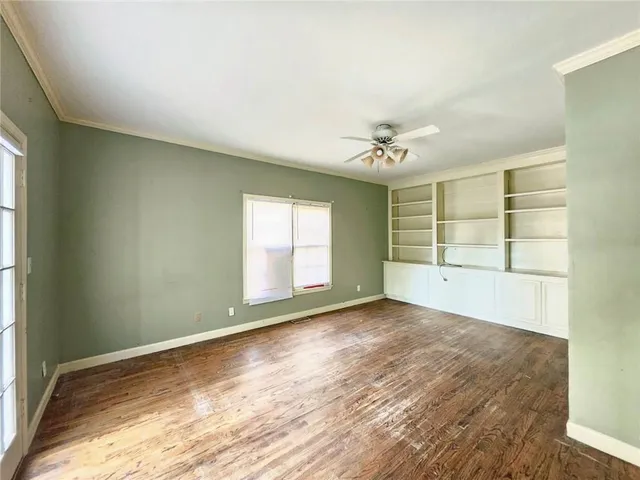 an empty room with windows and closet