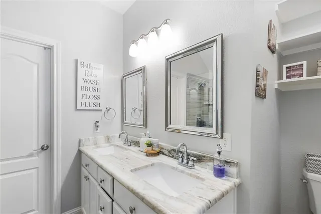 a bathroom with a sink vanity and a mirror