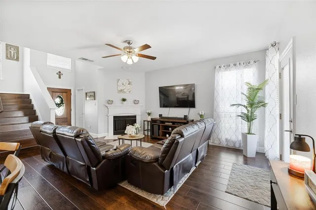 a living room with furniture a fireplace and a flat screen tv