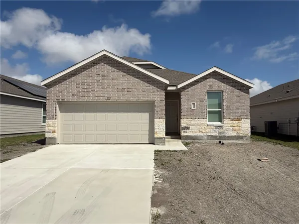 a kitchen with stainless steel appliances granite countertop a stove top oven a sink a refrigerator and white cabinets