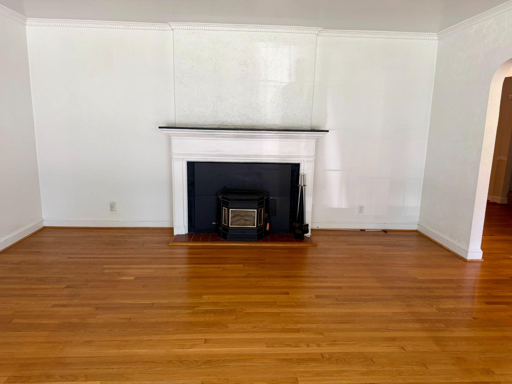 6318 Winner Avenue Baltimore, MD 21215 - Photo 12 of 75 a view of empty room with wooden floor and fireplace