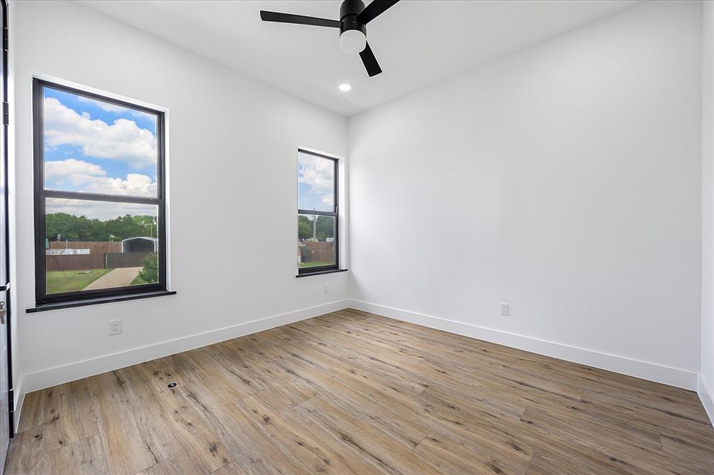 2811 Rodeo Drive Quinlan, TX 75474 - Photo 28 of 38 a view of an empty room with wooden floor and a window