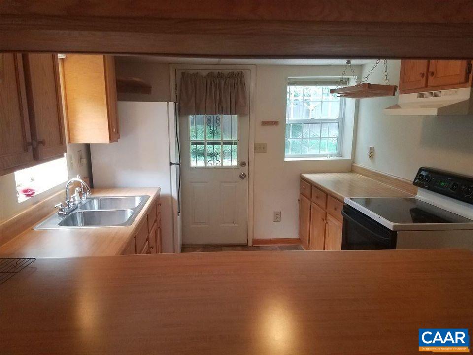 a kitchen with furniture and window