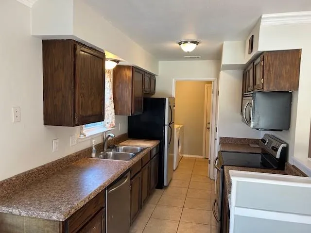 a kitchen with a sink and a refrigerator