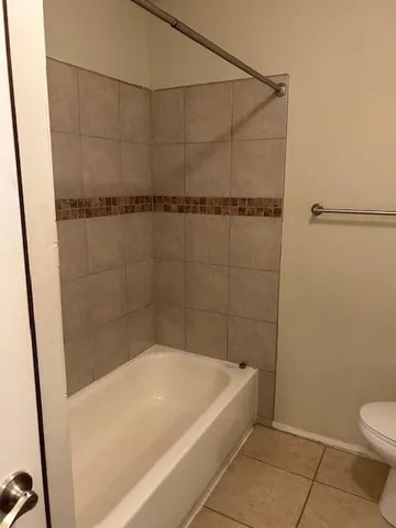 a bath tub sitting next to a toilet
