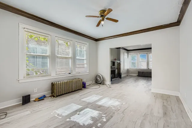 an empty room with windows and closet