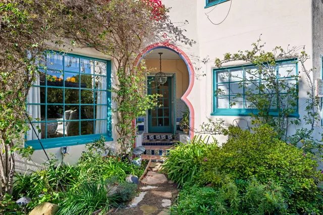 a front view of a house with a garden