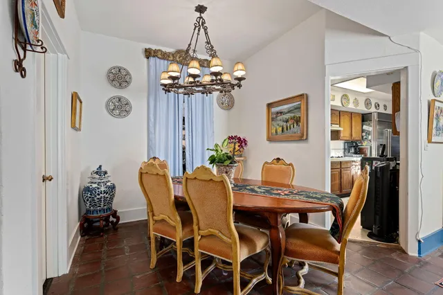 a view of a dining room with furniture and chandelier