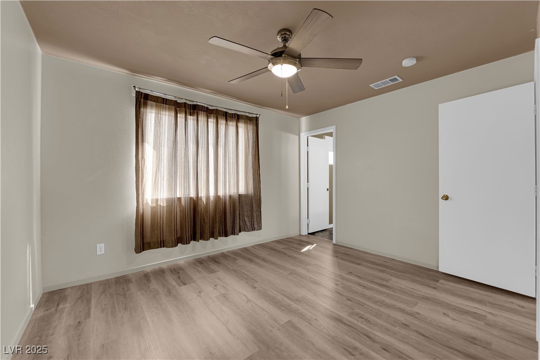 7572 Durham Hall Avenue, Unit 201 Las Vegas, NV 89130 - Photo 14 of 26 Unfurnished bedroom featuring light wood-style floors and ceiling fan