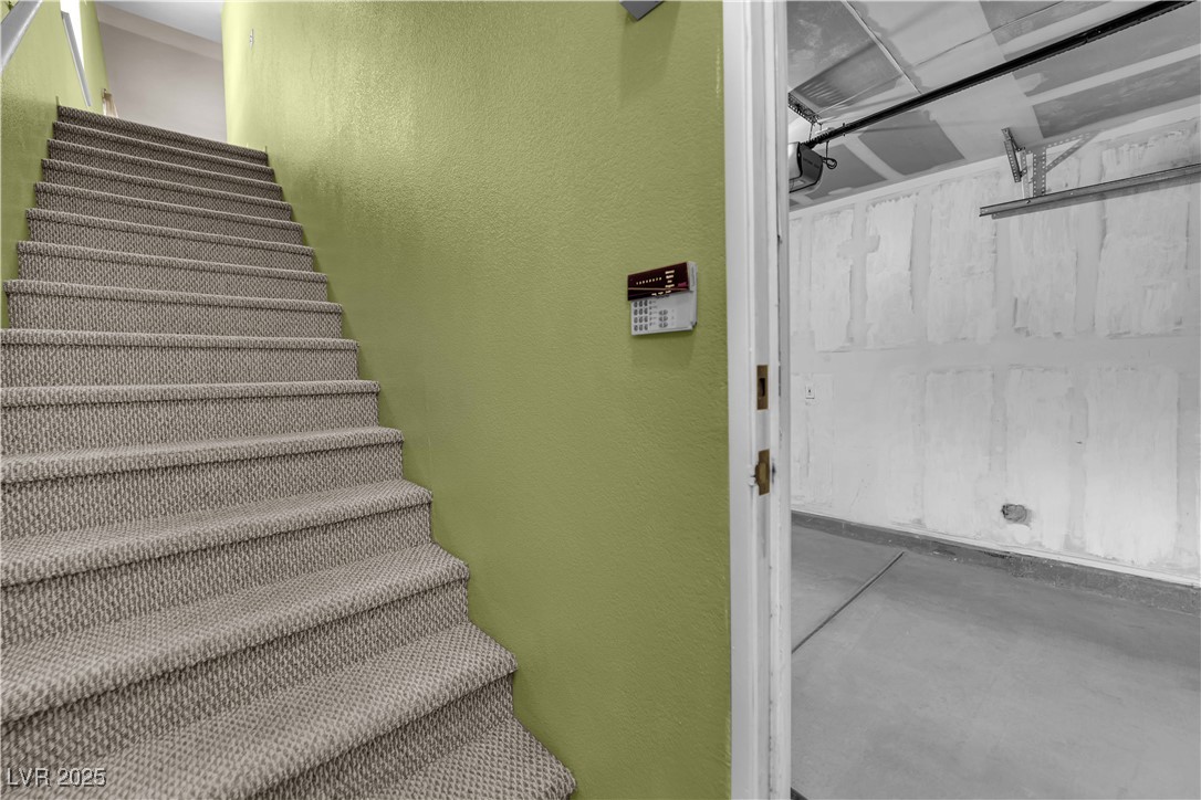 7572 Durham Hall Avenue, Unit 201 Las Vegas, NV 89130 - Photo 4 of 26 Stairway with concrete flooring