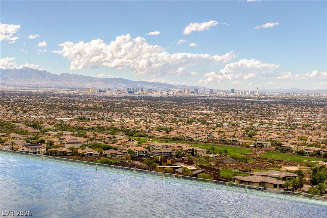 611 Cityview Ridge Drive Henderson, NV 89012 - Photo 55 of 66 A sweeping panorama captures distant city skyline and mountain views beyond the infinity pool edge.
