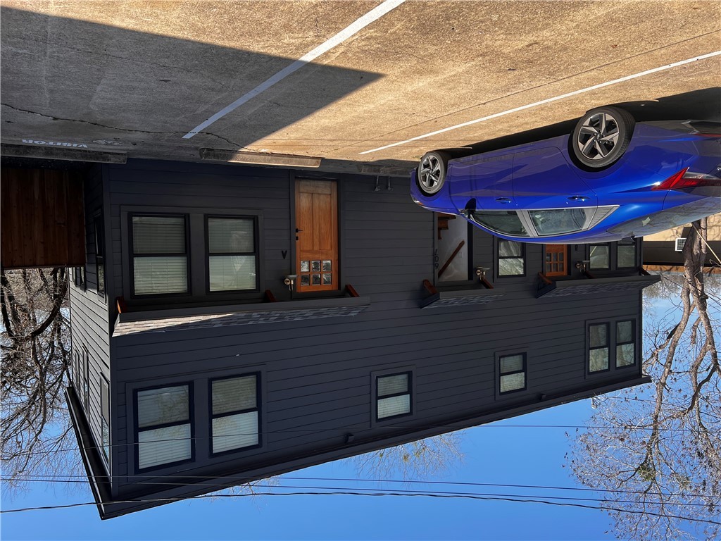 a view of a car parked front of a building