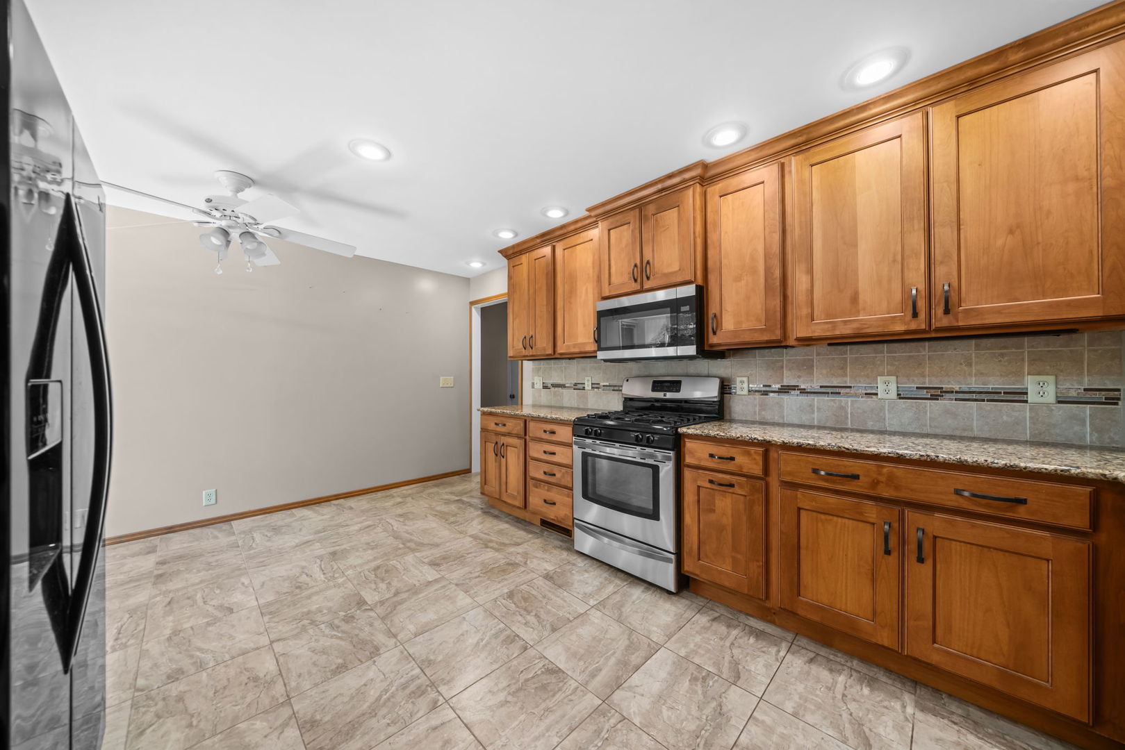 5748 South Skare Road Rochelle, IL 61068 - Photo 3 of 45 a kitchen with stainless steel appliances granite countertop a refrigerator a stove top oven a sink and dishwasher