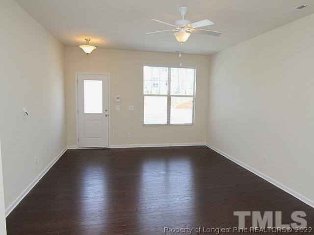 66 Intuition Circle Durham, NC 27705 - Photo 3 of 13 an empty room with wooden floor and windows