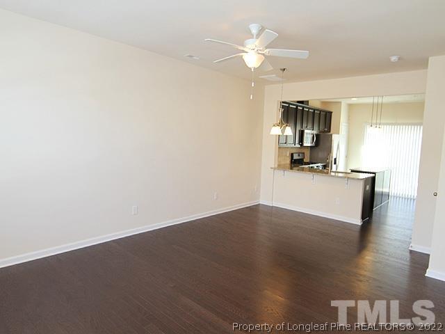 66 Intuition Circle Durham, NC 27705 - Photo 4 of 13 a view of a kitchen with wooden floor and a ceiling fan