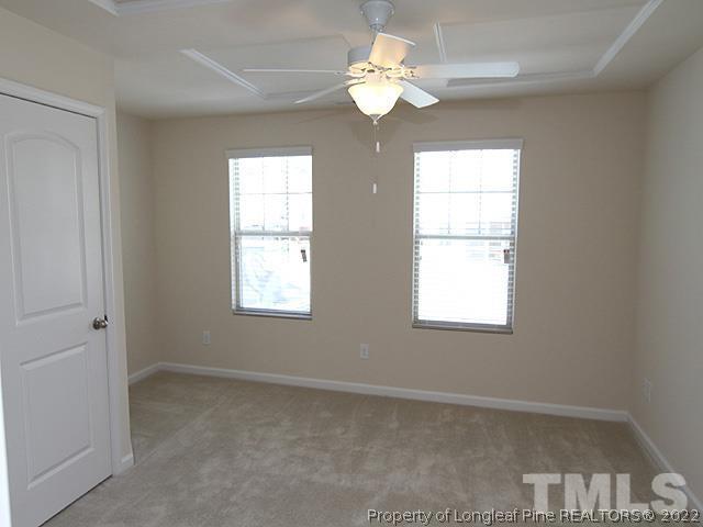 66 Intuition Circle Durham, NC 27705 - Photo 8 of 13 an empty room with windows and chandelier fan