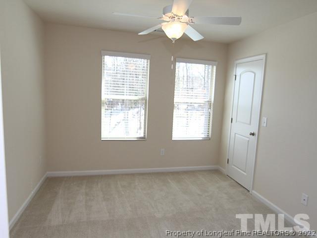 66 Intuition Circle Durham, NC 27705 - Photo 9 of 13 an empty room with windows and chandelier fan