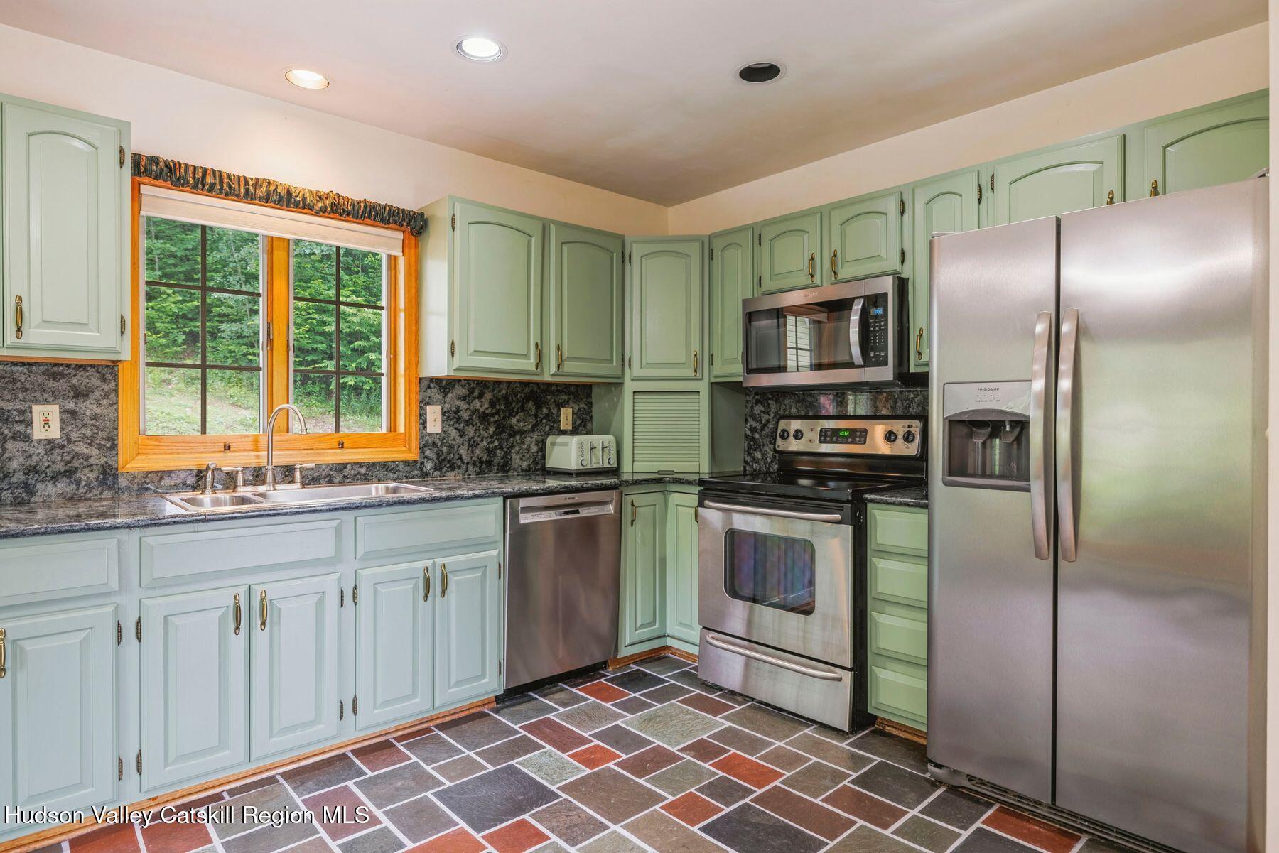 50 Halcott Ridge Road Shandaken, NY 12465 - Photo 9 of 28 a kitchen with stainless steel appliances granite countertop a refrigerator and a sink