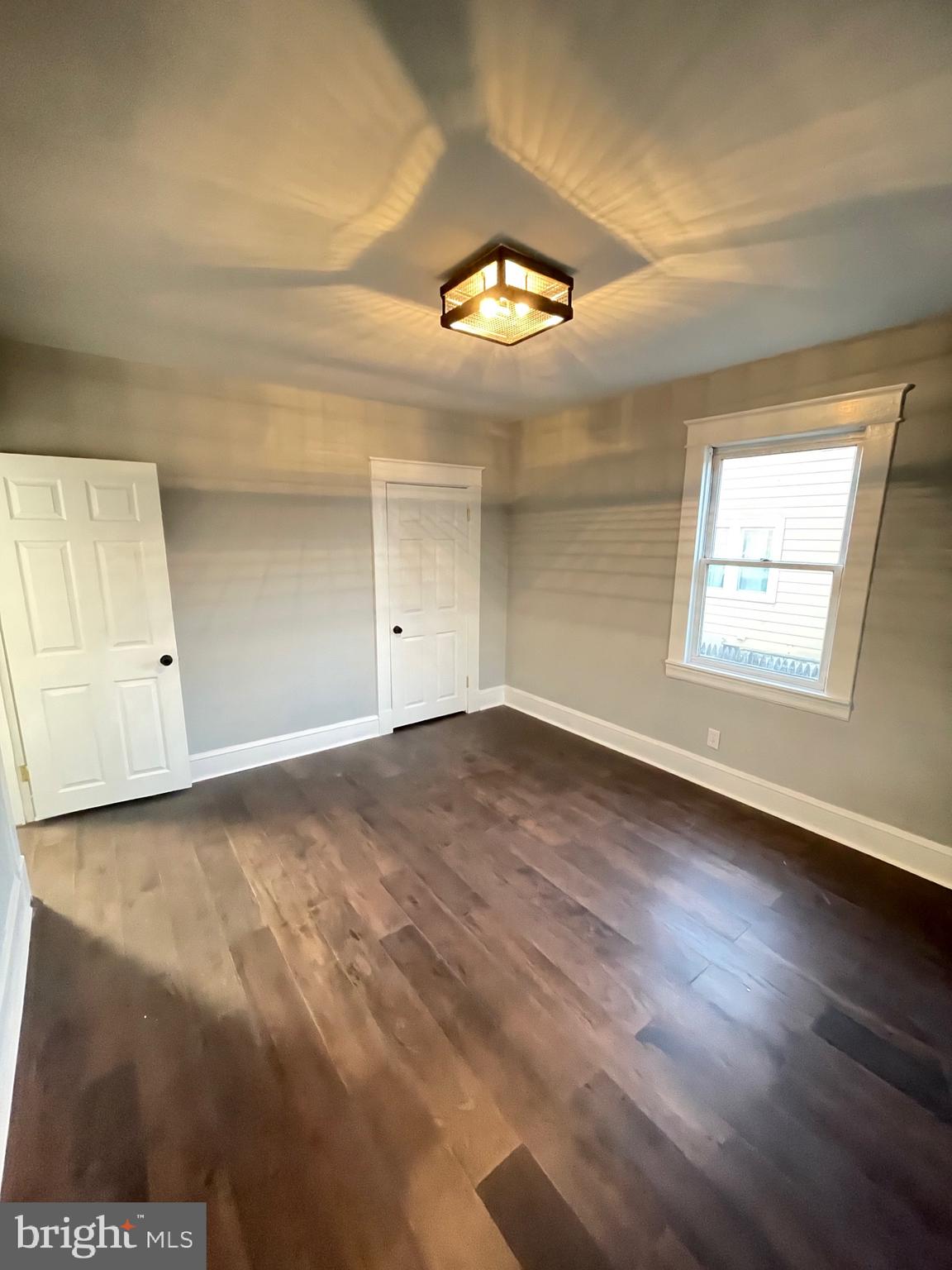 7350 Montgomery Road Elkridge, MD 21075 - Photo 21 of 44 an empty room with wooden floor and windows