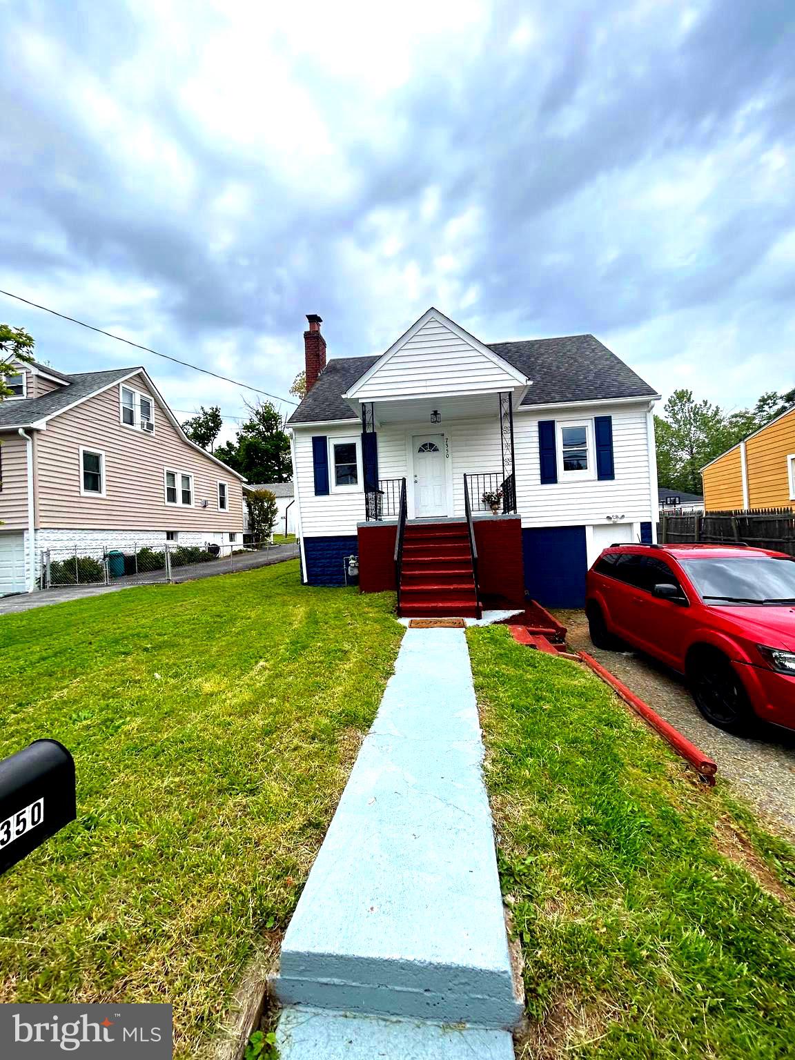 7350 Montgomery Road Elkridge, MD 21075 - Photo 4 of 44 a front view of a house with a garden and deck