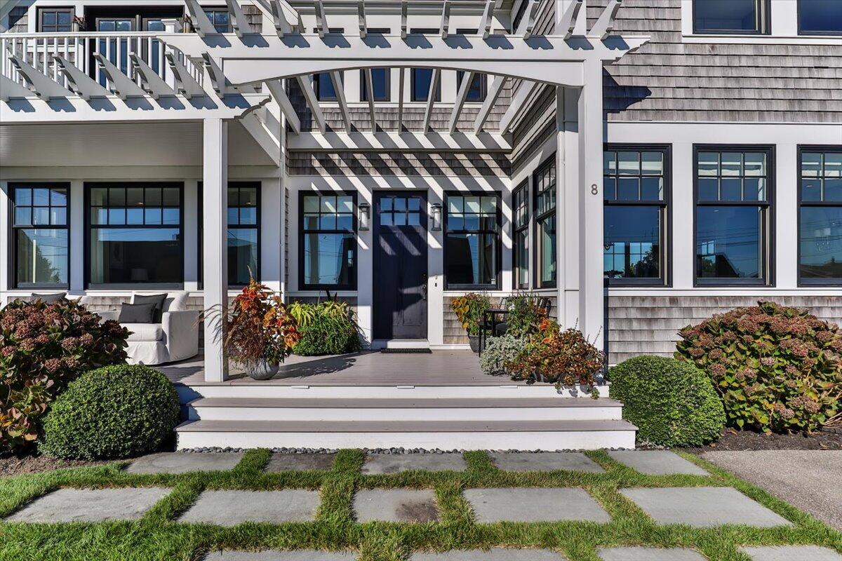 8 Beach View Road West Dennis, MA 02670 - Photo 8 of 81 a front view of a building with potted plants