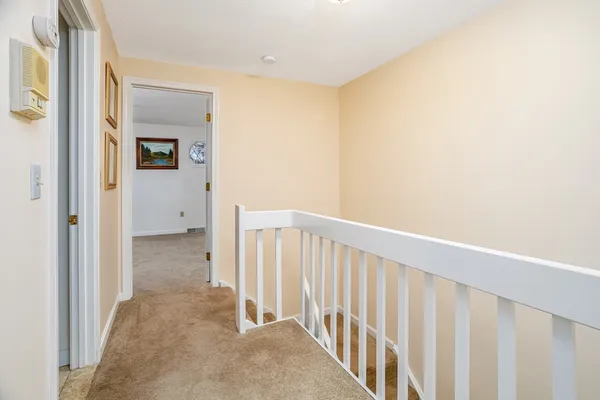 a view of a hallway with a wooden door