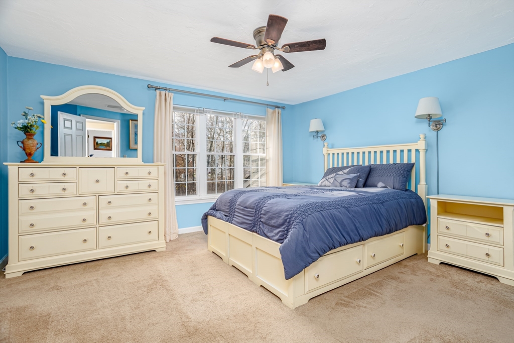 303 Ridgefield Circle, Unit C Clinton, MA 01510 - Photo 14 of 31 a spacious bedroom with a bed a dresser and a window