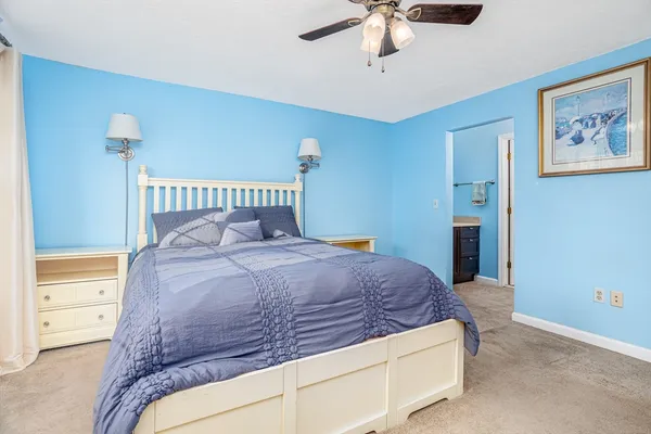 a bed sitting in a bedroom chandelier and a table
