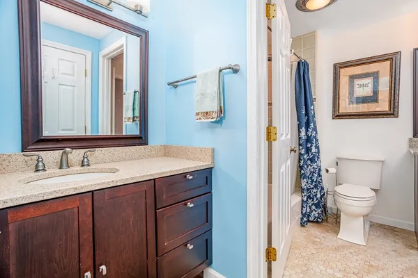 a bathroom with a sink a toilet and a mirror