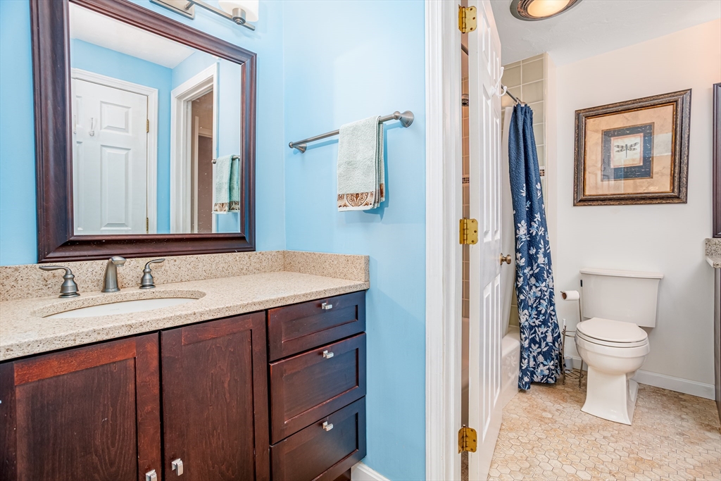 303 Ridgefield Circle, Unit C Clinton, MA 01510 - Photo 17 of 31 a bathroom with a sink a toilet and a mirror
