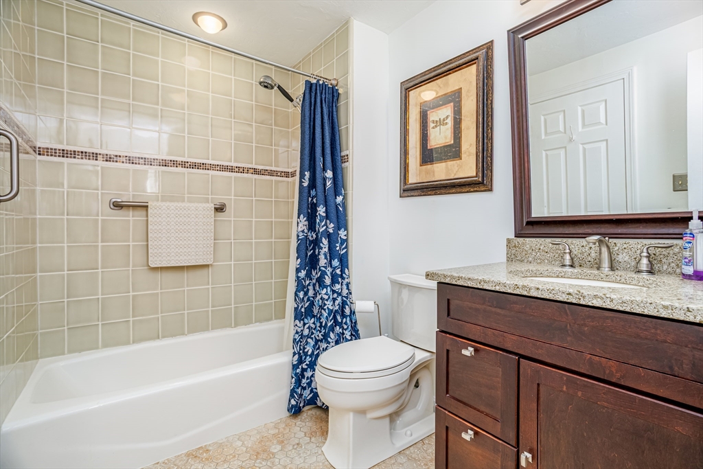 303 Ridgefield Circle, Unit C Clinton, MA 01510 - Photo 18 of 31 a bathroom with a granite countertop sink toilet and shower