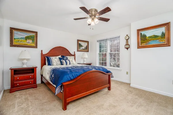 a bed sitting in a bedroom next to a window