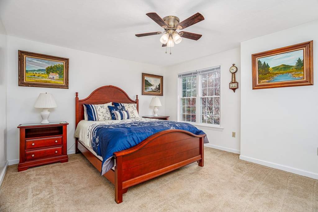 303 Ridgefield Circle, Unit C Clinton, MA 01510 - Photo 19 of 31 a bed sitting in a bedroom next to a window