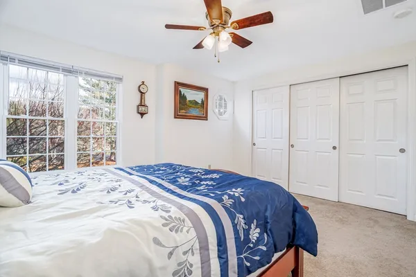 a bedroom with a large bed and a window