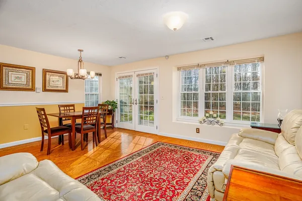 a living room with furniture a rug and a large window