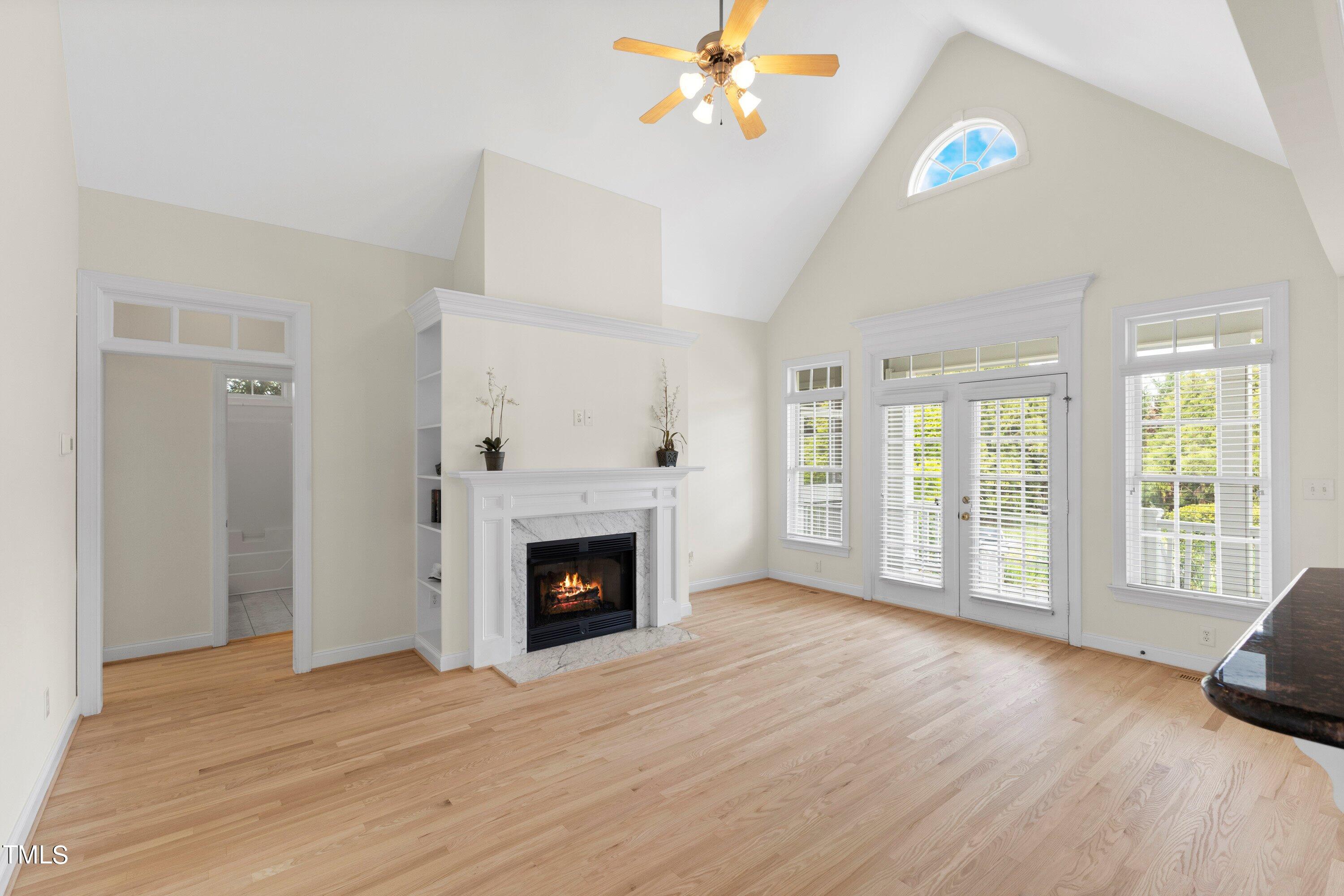 1004 Pasture View Lane Raleigh, NC 27603 - Photo 10 of 48 The open family room has a cathedral ceiling, gas fireplace, and built-in bookcases on each side of the fireplace. The doors lead to the covered and screened porch.