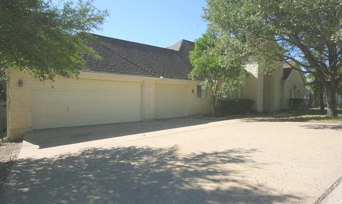 9405 Ashton Ridge Austin, TX 78750 - Photo 2 of 22 A well-maintained concrete driveway leads to a classic brick home with an attached two-car garage.