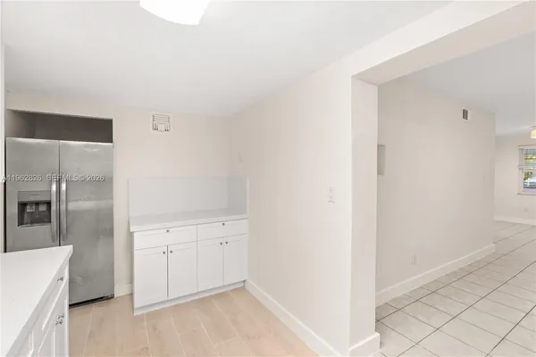 a kitchen with stainless steel appliances white cabinets and a stove top oven