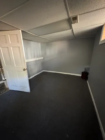 a bathroom with a granite countertop sink and a toilet