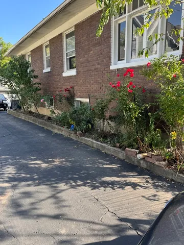 a view of a brick house with many windows