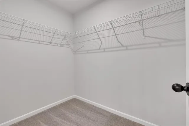 a white toilet sitting next to a white wall