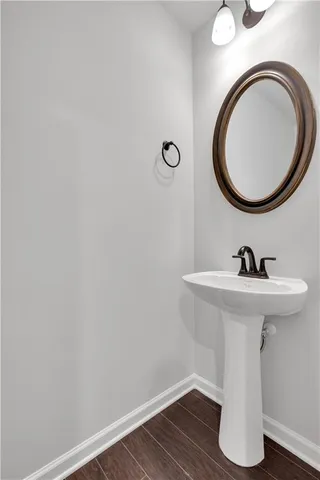 a white toilet sitting next to a white wall