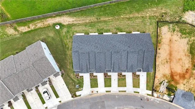 a view of house with garden space and car parked