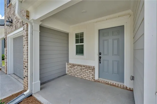 a view of a hallway with wooden floor and closet area